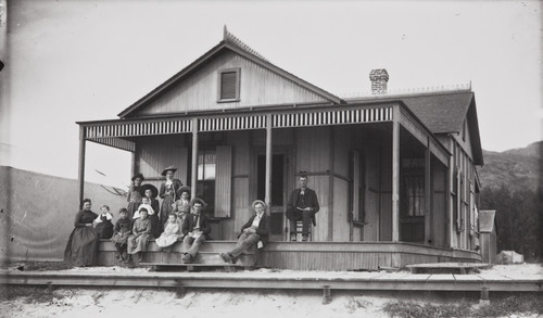 Photograph of family in front of beach cottage