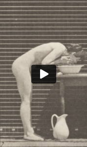 Nude woman washing face