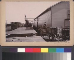 California Wine Association winery in Geyserville, California, with a wagon full of grapes approaching the loading dock, about 1890s