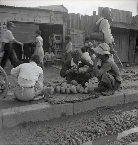 Street scene with fruit seller