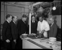 Board of Supervisors meets with local food kitchen chef, Los Angeles, 1934