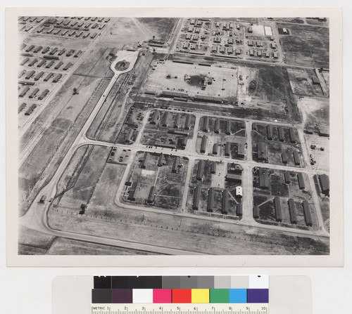 Tule Lake Center, 6 July 1945. Aerial view showing Military Police Area, left foreground, and WRA Adminstration Area in center and right background. Part of the evacuee area is shown beyond the fire break