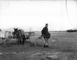 Fr. Anthony Cotta, MM, with his bicycle, China, ca. 1906-1919
