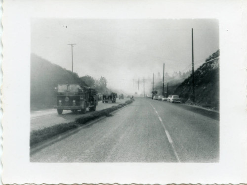 Fire trucks on the highway during a wildfire in Malibu, 1956