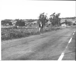 Doris Craig standing at the spot where the Bodega Road railroad station was located, Petaluma, California, 1962