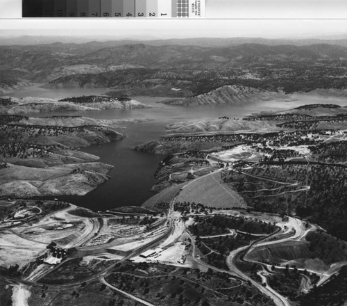 Aerial view of the new Don Pedro Dam with old dam submerged, May 22, 1971