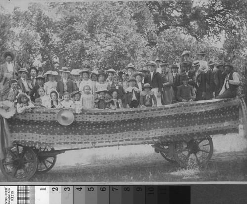 Forty four members of a Sunday School pose in a wagon parked under an Oak tree, circa 1895