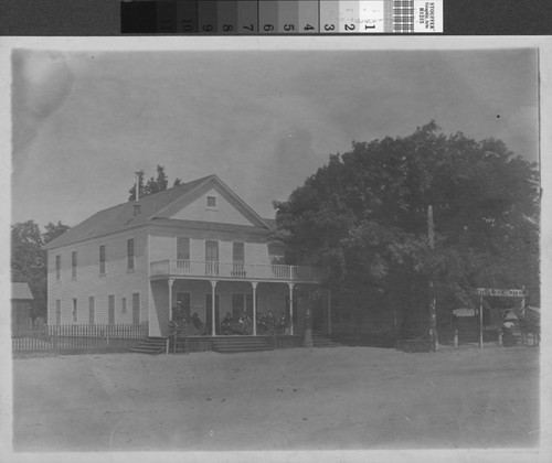 Unidentified men lounge on the porch of the Turlock Hotel, circa 1906