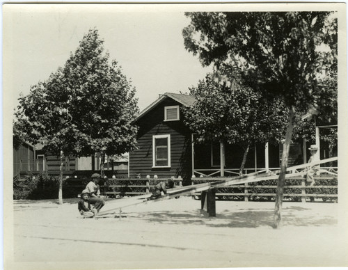 Children play on a teeter-totter in Turlock, California, circa 1930