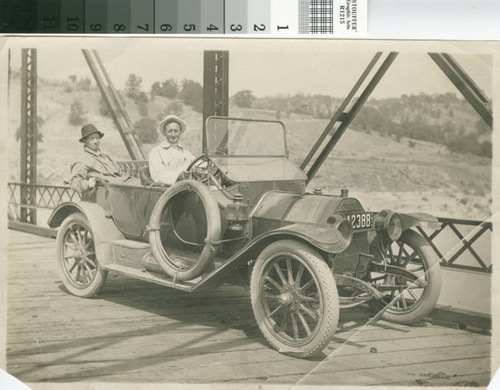 Two men in an automobile are halted on a bridge near Turlock, California in 1914