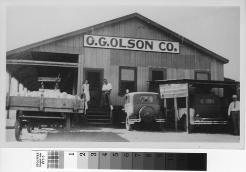 Unidentified people are outside the O. G. Olson Company in Turlock, California, circa 1935