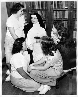 [Sister Mary with a group of girls in the library at the Home of the Good Shepherd]