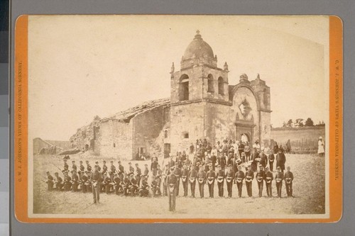 [Uniformed cadets and soldiers (?) in front of San Carlos mission, Carmel: occasion of the opening of grave of Father Junipero Serra. July 3, 1882. (Not stereographic)]