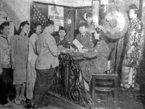 Los Angeles Chinese Aid Bond Drive. Enlisting thier aid in the Third War Loan Drive, Chinese residents of Los Angeles have opened a new bond booth at at China City. shown are Diana Got, Lillian Luck, Flora Yuen, and bond buyer Harry King. At the table are Dorothy Lum, Dorothy Siu, and Vivian Chinn, members of the Chinese branch of American Women's Voluntery Sercive (AWVS). In the rear are Choey Low Fong and Margaret Kwong. Bond selling at Union Station China City 721 N. Main