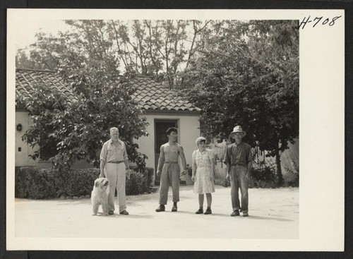 Left to right, Dr. Sydney Walker, Evan Oyakawa, his sister Lily, and their father Yokichi pose before the modern tile