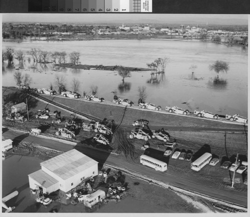 Photograph of heavy equipment lined up to repair levees on the Feather River in Yuba City (Calif.)