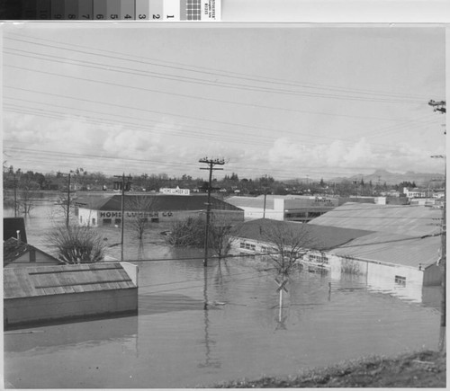 Photograph of Sutter Street buildings under water from the 1955 flood