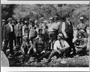 Members of the Sunset Club posing near a mountain stream, ca.1910