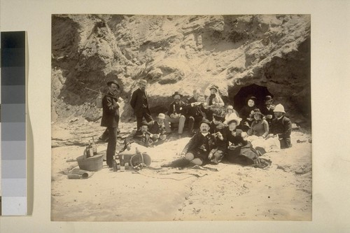 [Large family group picnicking on the beach.]