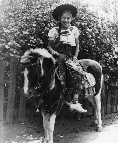 Mexican American girl on pony