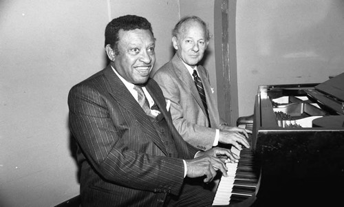 Lionel Hampton and an unidentified man sitting at a piano, Los Angeles, 1982