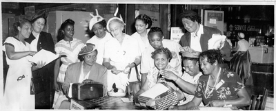 Group of women standing next to National Association of Colored Women information table