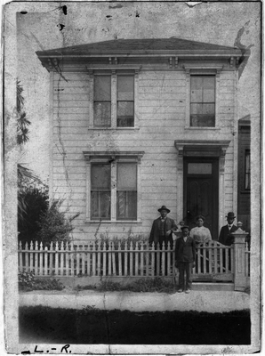 Rev. Francis T. Walkee, two men, woman, and child standing in front of house at 968 5th St. Oakland, California