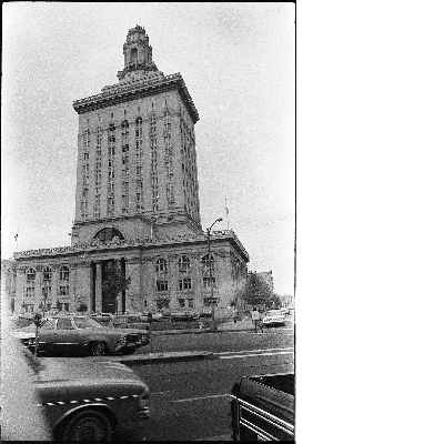 Automobiles parked in front of Oakland city hall