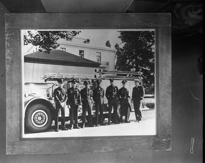 Firemen standing in front of fire truck