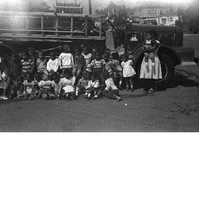 Students seated in front of fire engine