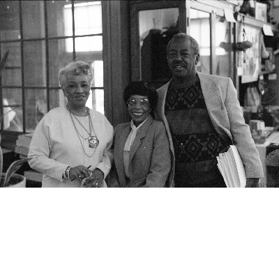 Morrie Turner posing with two women at the East Bay Negro Historical Society