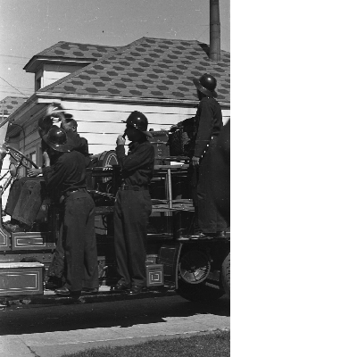 Group of Oakland firefighters standing on fire engine