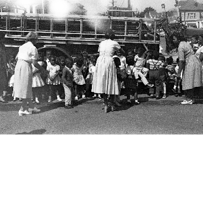 Students seated in front of fire engine