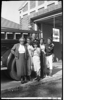 Fireman standing with group of women in front of fire station