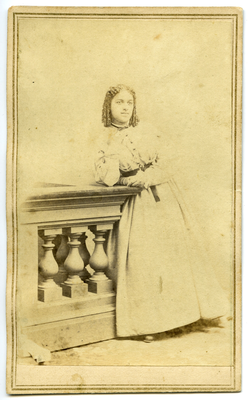 Portrait of unidentified girl leaning on balustrade