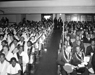 Masons and members of the Order of the Eastern Star seated in large banquet hall