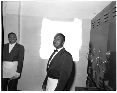 Two men wearing masonic aprons in locker room