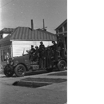 Group of Oakland firefighters standing on fire engine