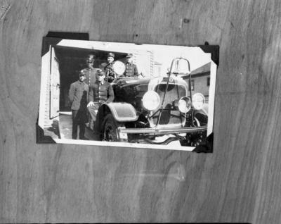 Five firemen sitting in fire truck