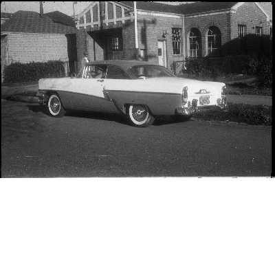 Automobile parked in front of Oakland Fire Department fire engine no. 22