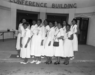 Group photograph of members of the Order of the Eastern Star standing in front of conference building