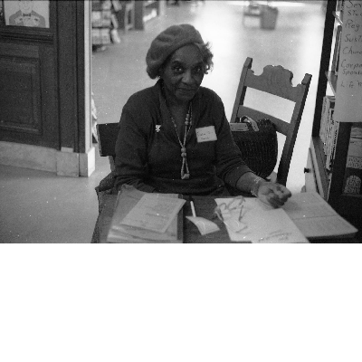 Frances Carr sitting at desk at the East Bay Negro Historical Society