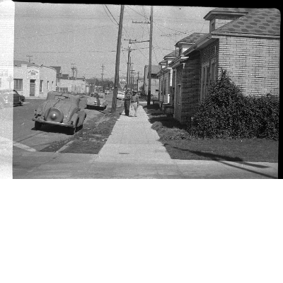 Two men walking on sidewalk