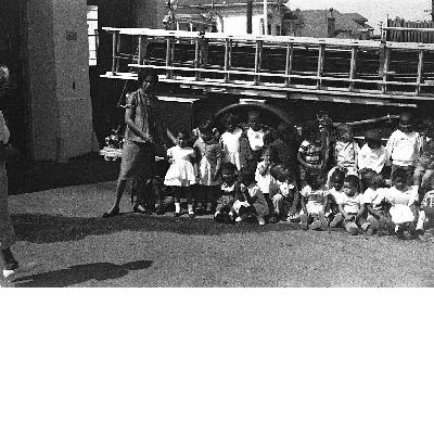 Students seated in front of fire engine