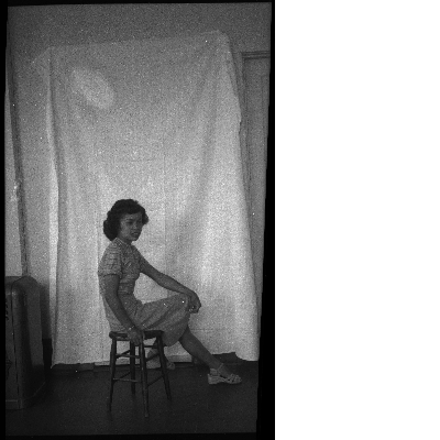 Woman sitting on stool for portrait