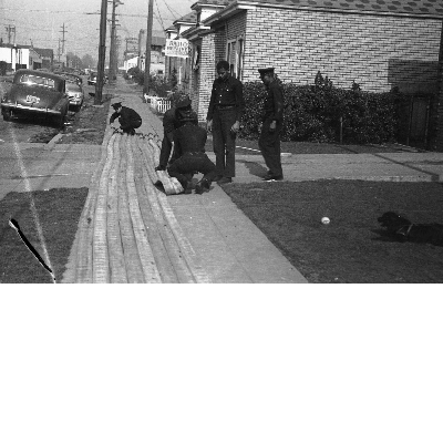 Firefighters rolling up fire houses on sidewalk