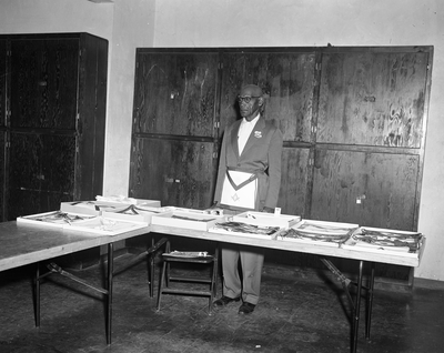 Man wearing masonic apron standing in front of table