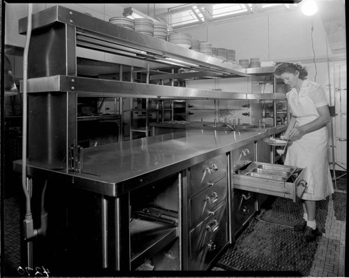 Lady preparing food in unknown commercial kitchen