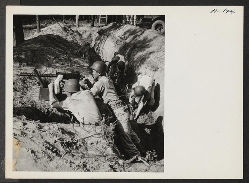 A machine gun crew protects trench diggers while they complete the work with the modern compressed air trench shovels. The