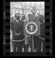 President Lyndon B. Johnson at podium looking towards Upper Voltian President Maurice Yaméogo, 1965 [11_1]